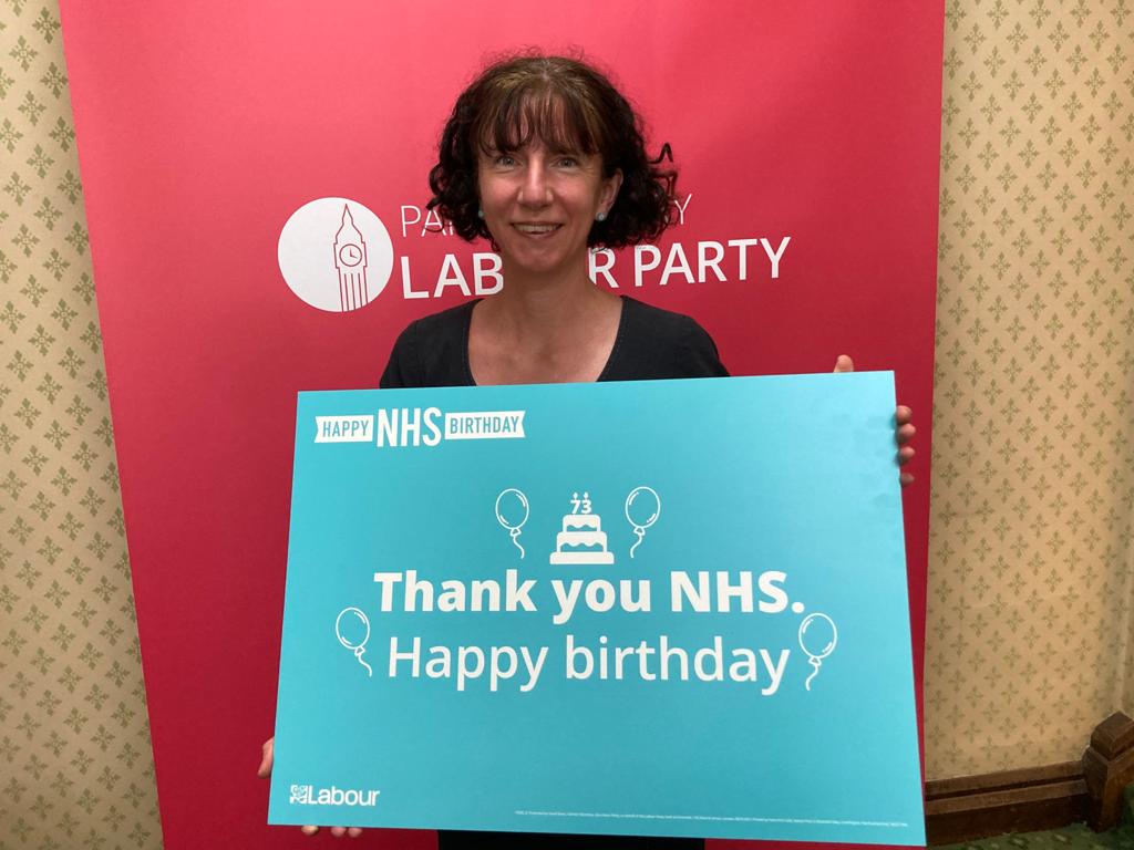Anneliese holding a placard which says