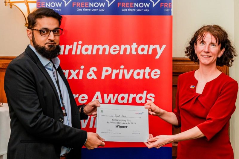 Anneliese Dodds presenting Sajad Khan with a certificate in front of a banner that says Parliamentary Taxi and Private Hire Awards.