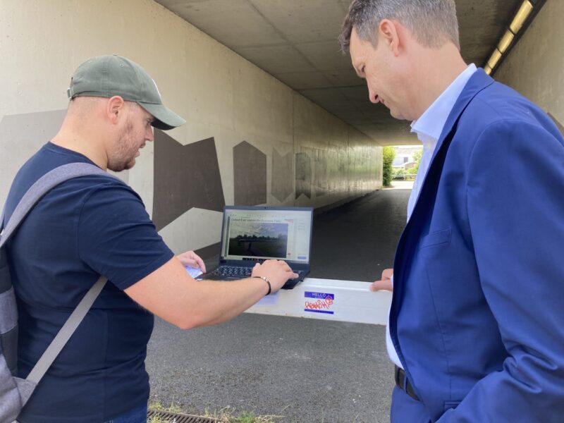 Markus Grüneisl being shown visualisations of the potential new station near Blackbird Leys.