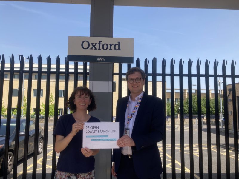 Anneliese Dodds MP and a representative from Network Rail at the end of the walk in front of the Oxford Station sign.
